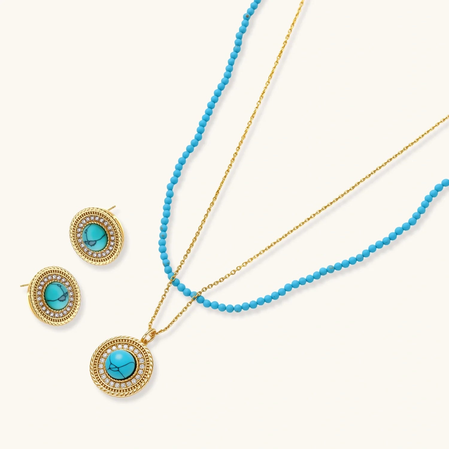 Gold-plated turquoise jewelry set with circular medallion pendant, beaded necklace, and matching stud earrings on white background