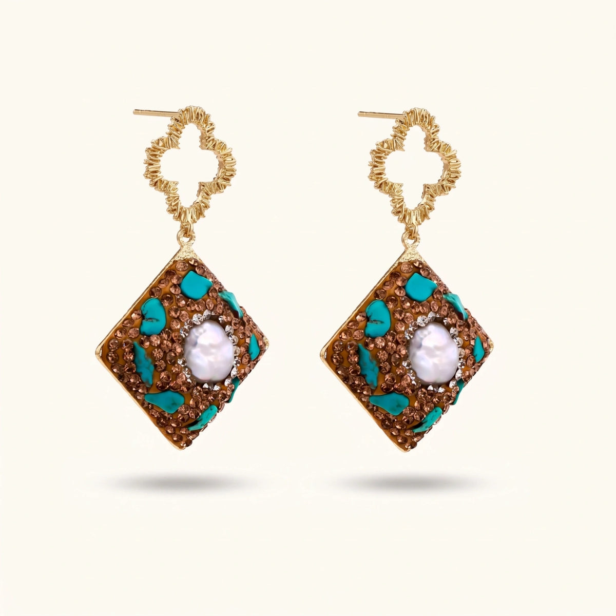 Gold-plated drop earrings with quatrefoil studs, diamond-shaped pendants featuring baroque pearls, turquoise stones, and amber crystals