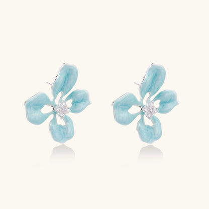 Turquoise enamel flower stud earrings with marbled finish and crystal centers on 18K gold plated brass