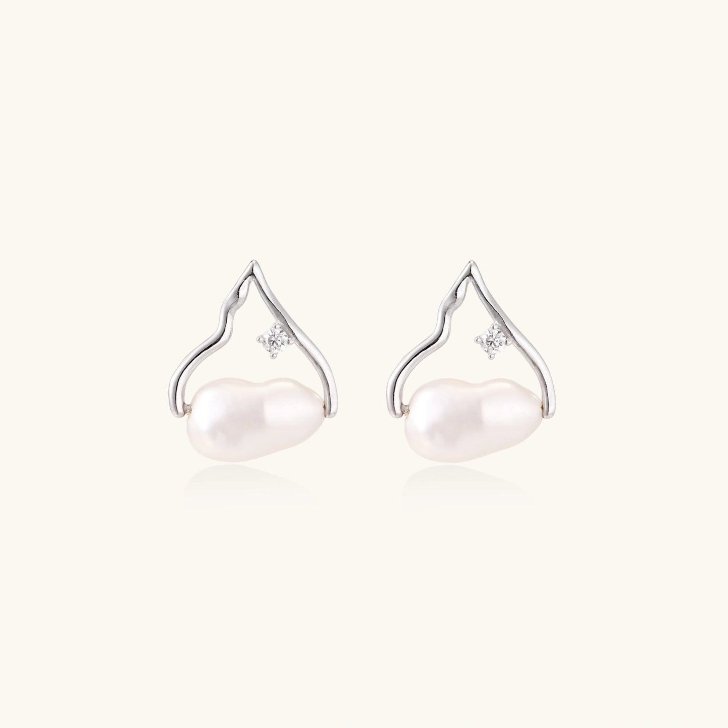 Silver mountain outline studs with baroque pearl and diamond accent on white background