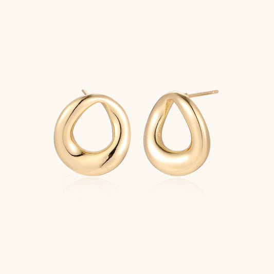 Pair of polished 18K gold-plated stainless steel teardrop earrings with hollow centers on cream background