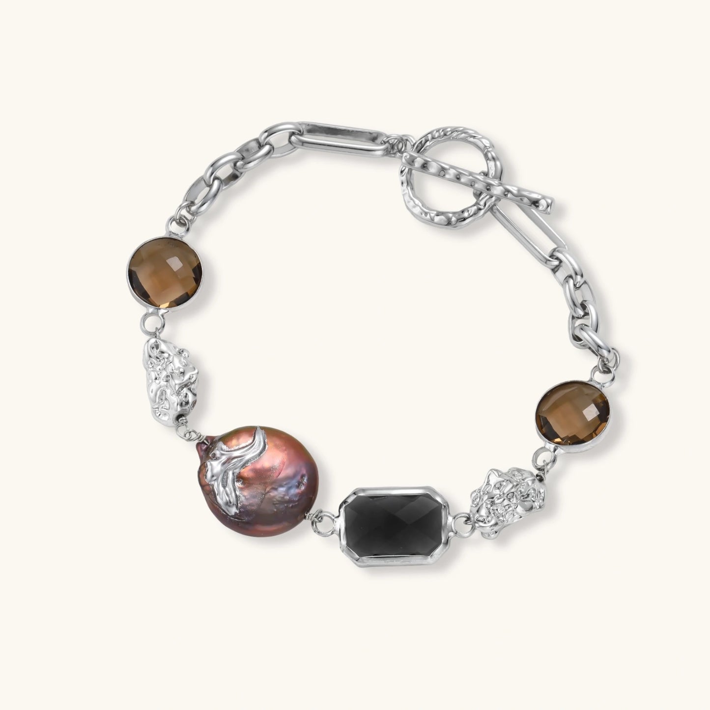 Chain bracelet with amber stones, baroque pearl, and dark rectangular stone on white gold-plated copper base.