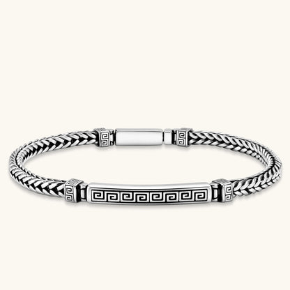 Silver stainless steel men's bracelet with braided foxtail chain, Greek key engraved bar, and decorative cube connectors.