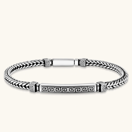 Silver stainless steel men's bracelet with braided foxtail chain, Greek key engraved bar, and decorative cube connectors.