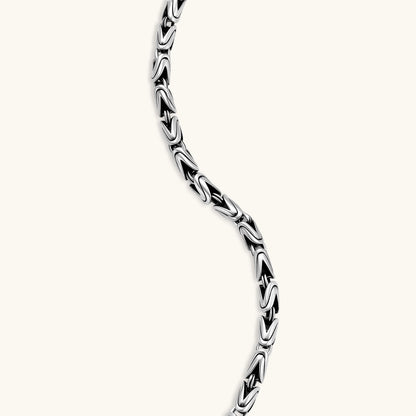 Men's antique silver Byzantine chain necklace, 6.2mm wide interlocking S-link pattern with ornate lobster clasp, 560mm length.